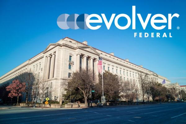 Evolver Federal logo in the sky above the Robret F. Kennedy Department of Justice building in Washington, DC.